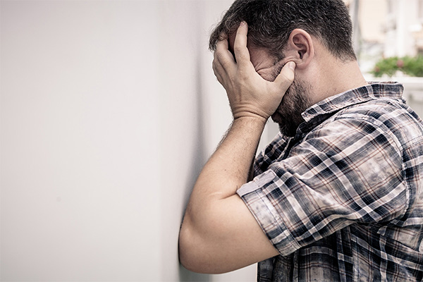 portrait-one-sad-man-standing-near-a-wall-and-PAFEDTL.jpg